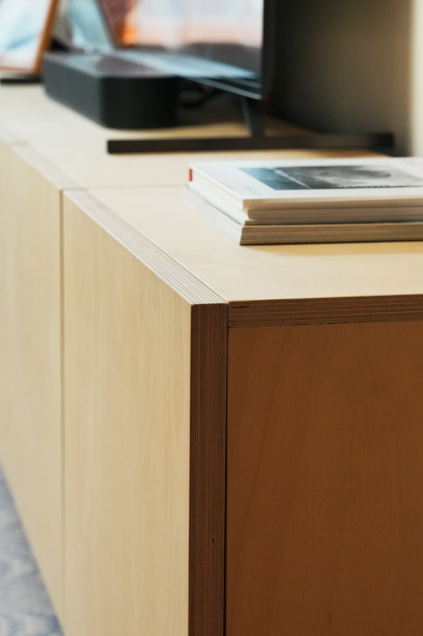 Wooden modular shelving units with cabinet edge and mitred corner detail
